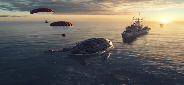 Orion spacecraft capsule in Pacific Ocean with parachutes and naval recovery ship at dawn