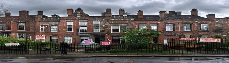 Panoramic view of a row of terraced red-brick Dublin houses on a quiet street, wrought-iron railings and dark front doors with brass numbers, For Sale signs in front gardens, damp morning pavement, overcast grey Irish sky, no people no faces no hands